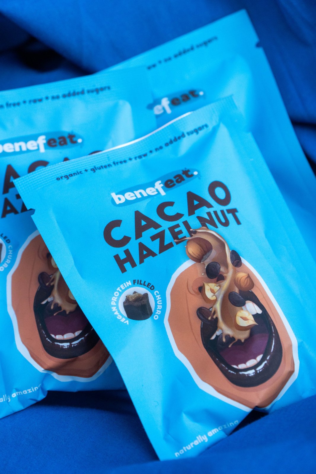 Cacao Hazelnut packs on a blue fabric