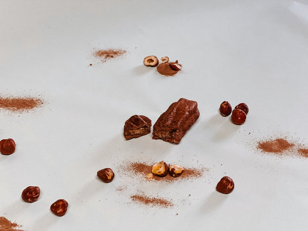Cacao churro broken in two, showing the hazelnut filling