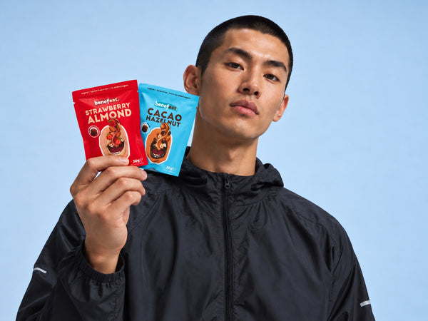Man holding Strawberry Almond and Cacao Hazelnut packs