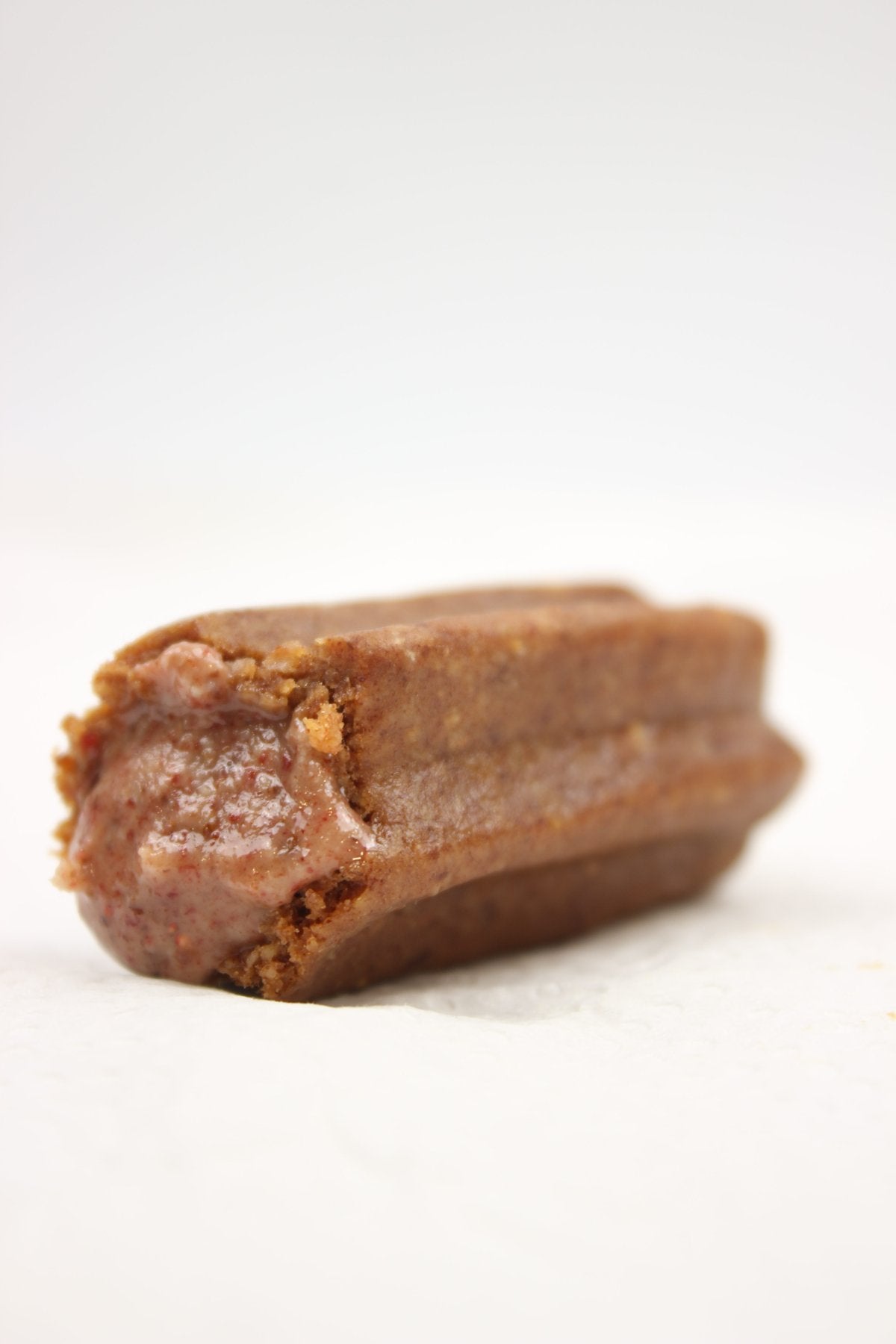 Close-up of an almond churro with its strawberry filling